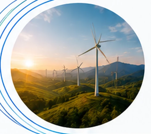 Wind turbines across a mountainous landscape at sunset